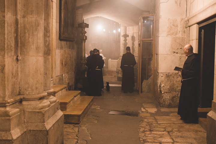 Pilgrims gathered in the courtyard before the facade of the Church of the Holy Sepulchre in Jerusalem's Old City
